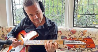 Robin Nolan wears headphones and plays a Fireglo Red Rickenbacker 