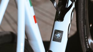 A close up of the NFC tag on the downtube of a Colnago C68