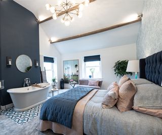 bath in bedroom on small blue patterned tiled section of floor