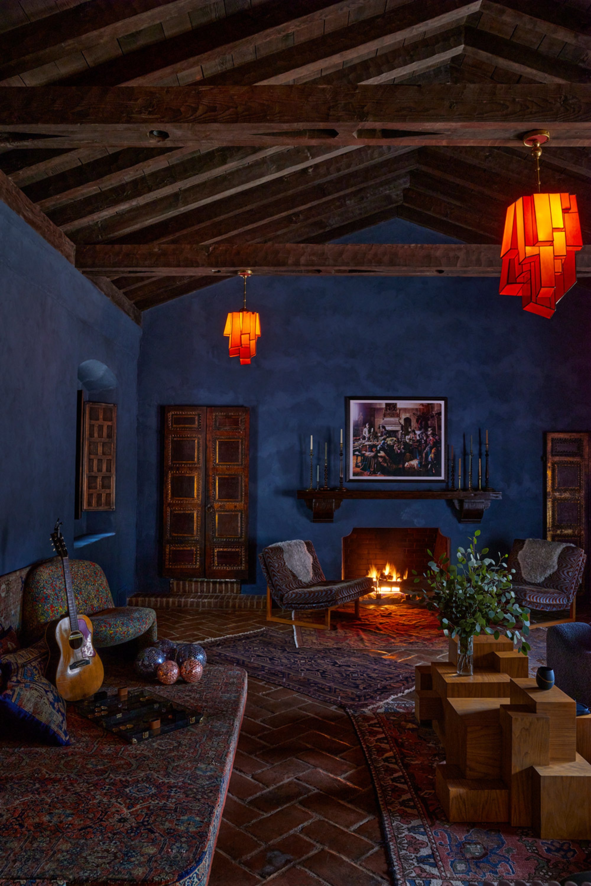 a large blue-walled property with rustic styling and art deco style lighting