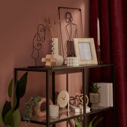 Red wall with shelves covered in ornaments