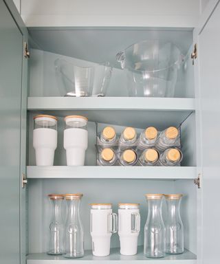 House of Prim organizational kitchen cabinet full of glassware and drinks pitchers