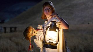 A little girl holds a doll in Annabelle: Creation