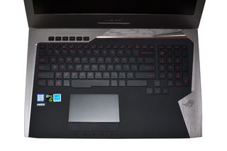 Full size keyboard with 10-key, macro keys, and a large touchpad with discrete buttons