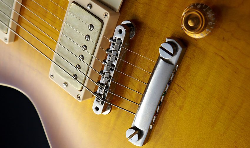 The R9's bridge has no retaining wire for the screws, so be careful when you're restringing
