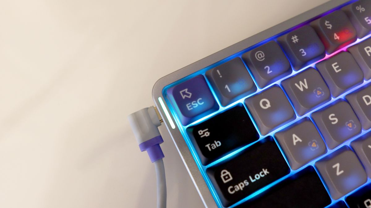 NuPhy Air60 HE gaming keyboard on a desk with RGB enabled.