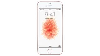 The front of a white and rose gold iPhone SE. Showing a pink flower wallpaper on screen.