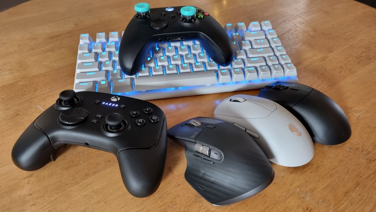 A selection of gaming peripherals including the Razer Wolverine V3 Pro, the Alienware Pro keyboard, the Logitech MX Master 3s, the Alienware Pro mouse, and a Glorious rodent