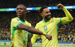 Vinicius Junior and Matheus Cunha of Brazil celebrate after scoring the team's first goal during the FIFA World Cup 2026 South American Qualifier between Brazil and Paraguay at Neo Quimica Arena on June 10, 2025 in Sao Paulo, Brazil. 