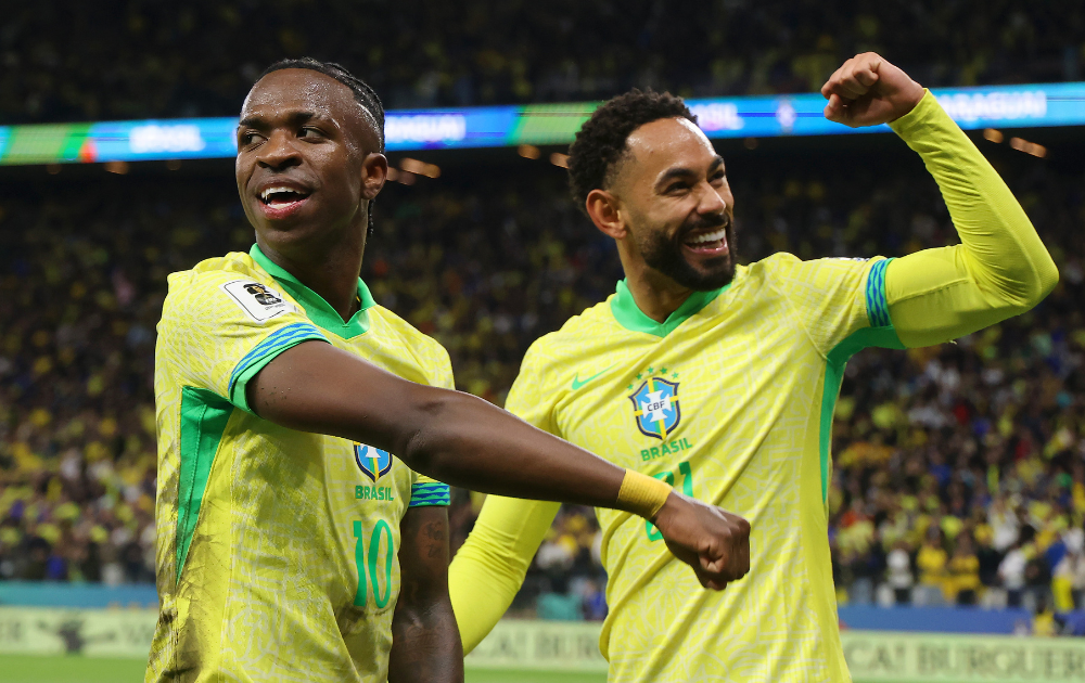 Vinicius Junior and Matheus Cunha of Brazil celebrate after scoring the team's first goal during the FIFA World Cup 2026 South American Qualifier between Brazil and Paraguay at Neo Quimica Arena on June 10, 2025 in Sao Paulo, Brazil. 