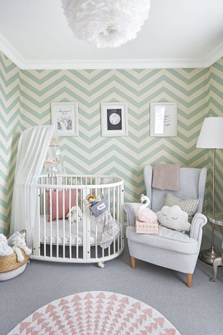 nursery with bold green zig zag wallpaper and pink accessories