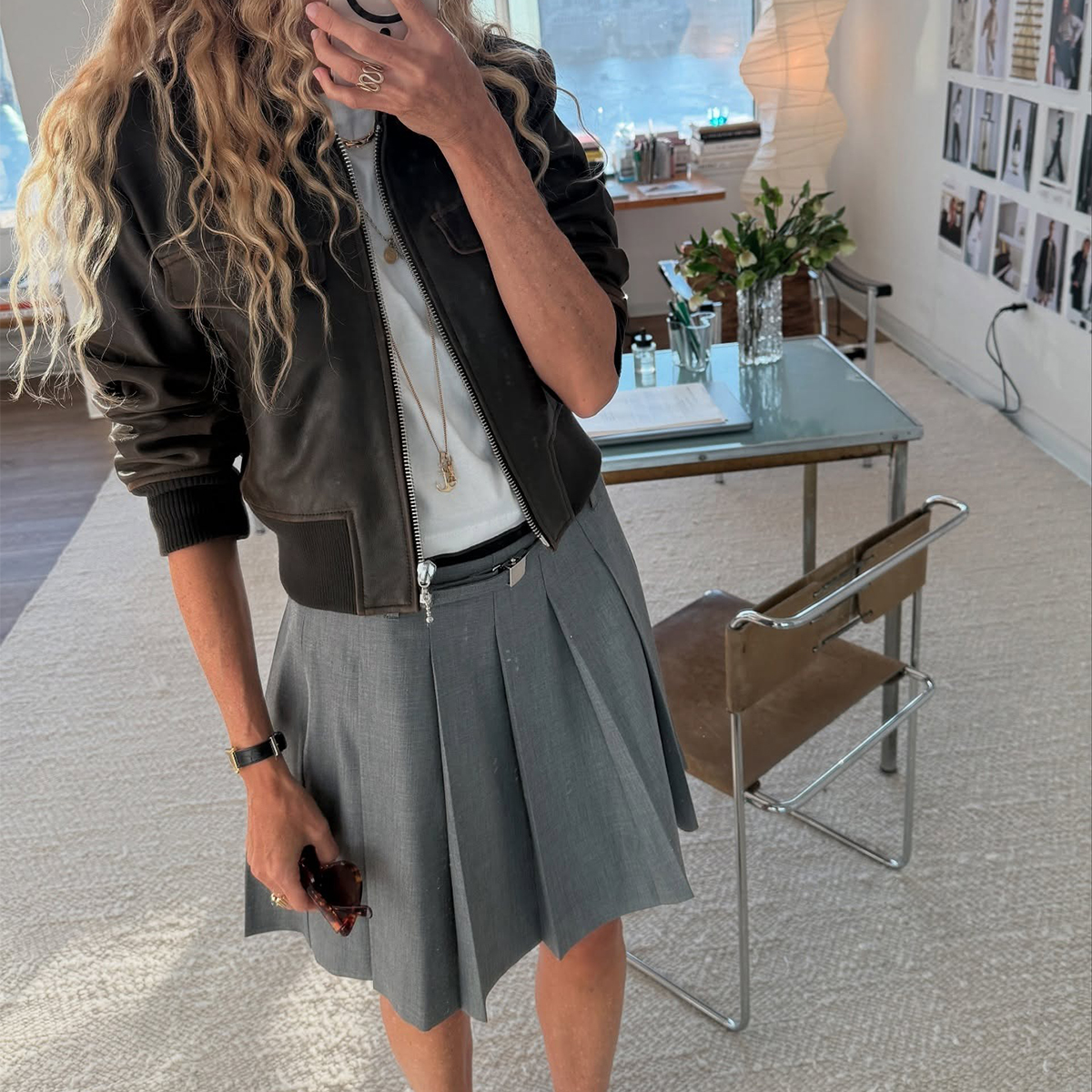 Olympia Marie is in a J.Crew pleated skirt and a leather jacket. J.Crew cinched waist sweater. J.Crew wide-leg jeans. Olympia Marie in a white tank, J.Crew pants, and gold jewelry. 