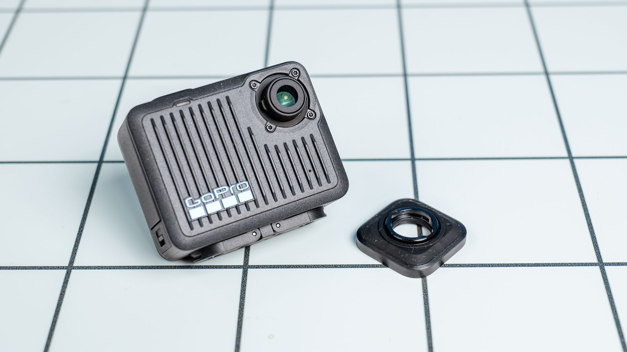 The GoPro Hero (2024) on a white surface with its lens guard removed