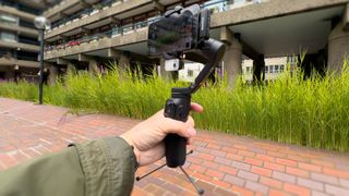 Hohem iSteady V3 gimbal being used to film a person on an iPhone