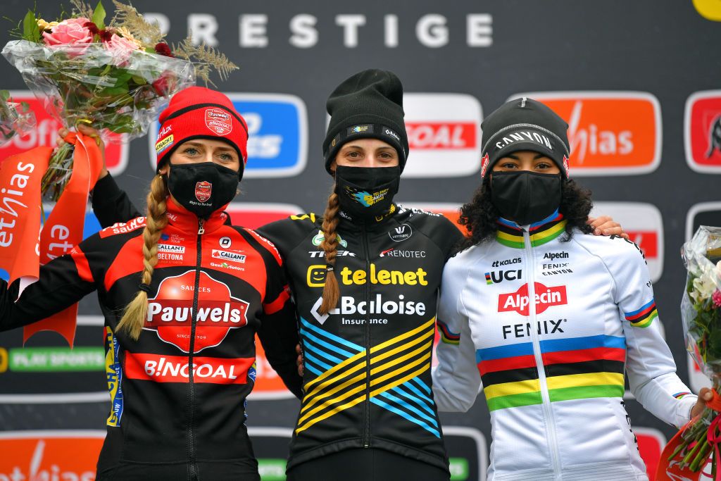 ANTWERPEN BELGIUM DECEMBER 13 Podium Denise Betsema of The Netherland and Team Pauwels Sauzen Bingoal Lucinda Brand of The Netherland and Team Telenet Baloise Lions Ceylin Del Carmen Alvarado of The Netherland and Team AlpecinFenix Celebration Mask Covid safety measures Flowers during the 21st Superprestige Gavere 2020 Women Elite Superprestige2021 SPGavere SuperprestigeCX on December 13 2020 in Antwerpen Belgium Photo by Luc ClaessenGetty Images