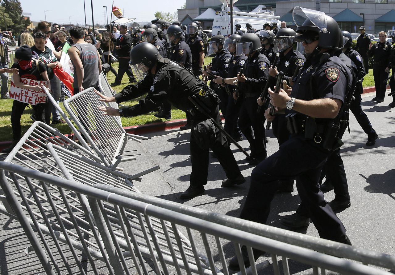 Police officers clash with protesters outside California&amp;#039;s Republican Party convention.