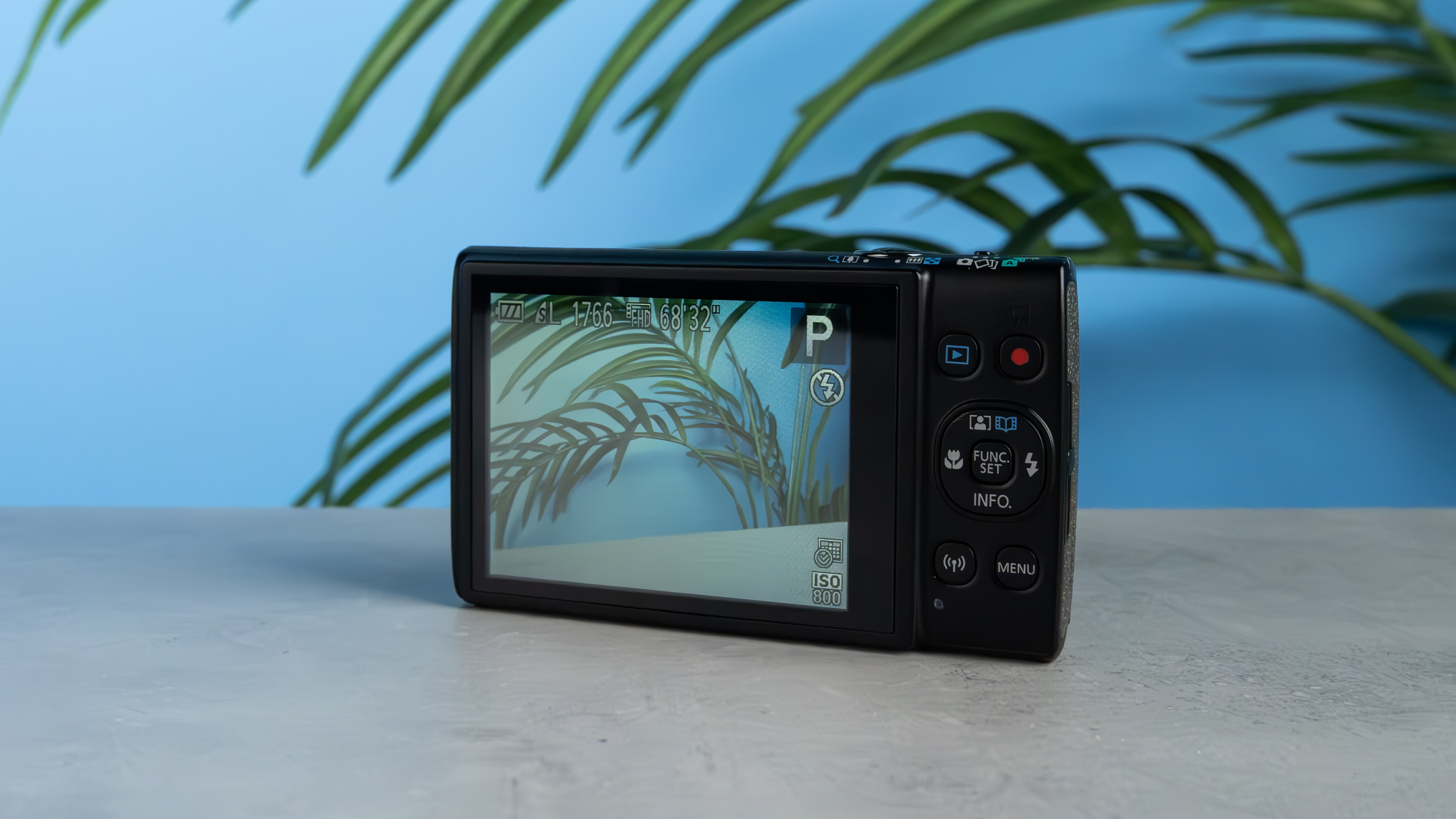 A black Canon PowerShot Elph 360 HS A or Canon PowerShot IXUS 285 HS A compact camera