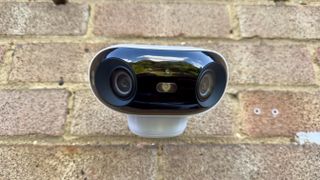 Reolink Argus 4 Pro security camera attached to a brick wall