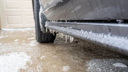 A car on a driveway which is icy