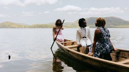 The three girls pose for a proper fashion shoot moment by the river. It is an emotional moment for them, even though posing in the sweltering heat is hard work. 