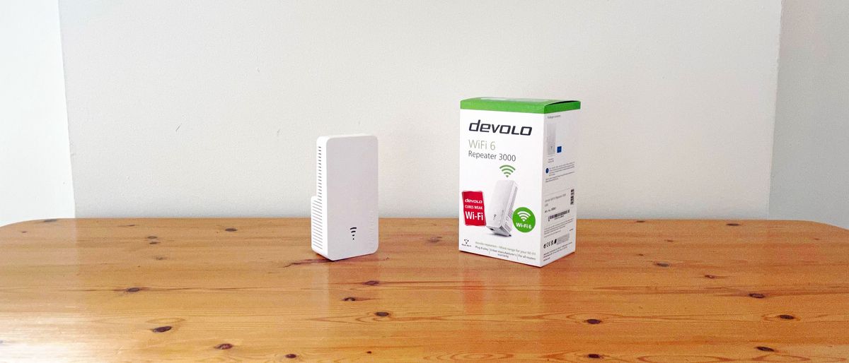 Devolo WiFi 6 Repeater 3000 on a wooden desk