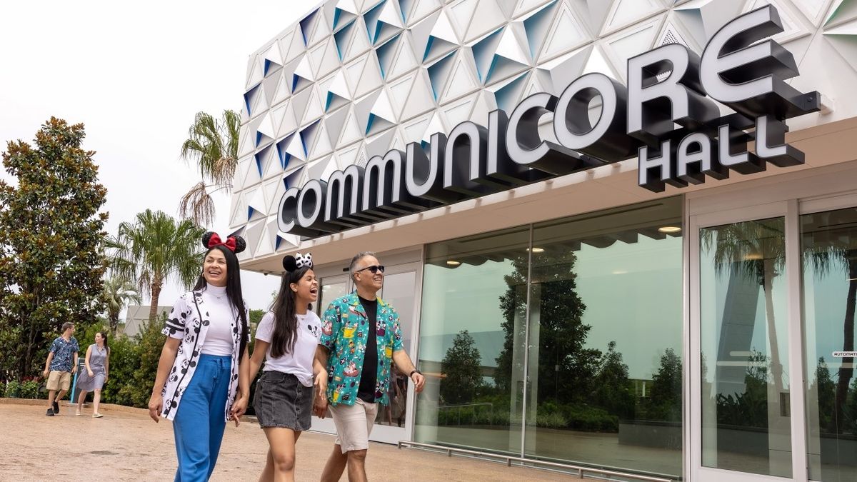 people walking across the front of Communicore hall at Epcot