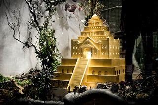 Model temple with miniature figures in a window display