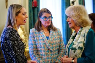 Camilla, Duchess of Cornwall talks with guests during a reception at Clarence House in London to mark 50 years of Refuge