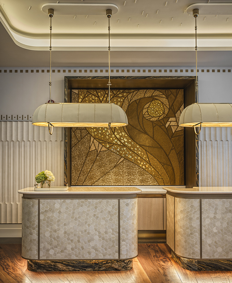 Mandarin Oriental Vienna reception desk with golden artwork behind it
