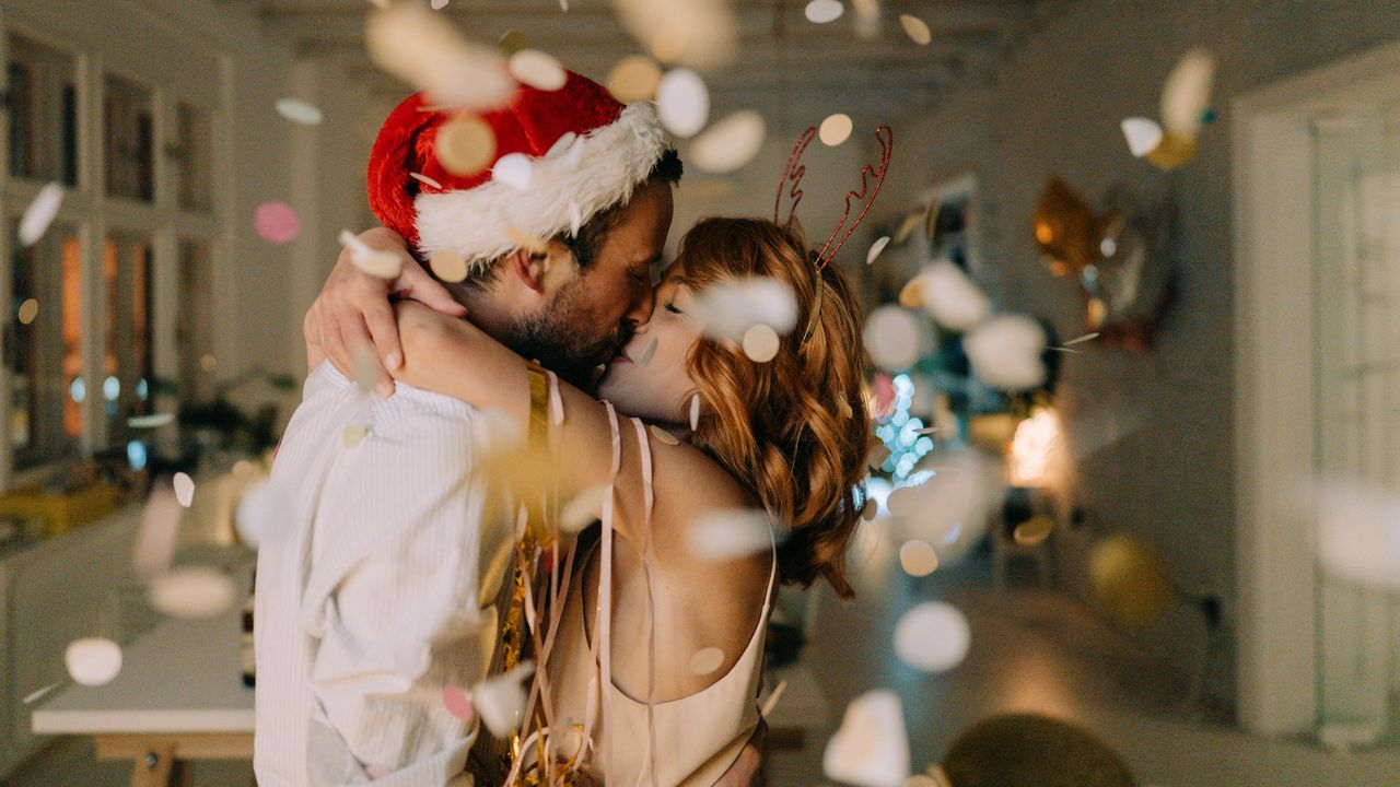 A couple kissing at a Christmas party