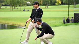 Si Woo Kim and Tom Kim during a practice round before the Presidents Cup