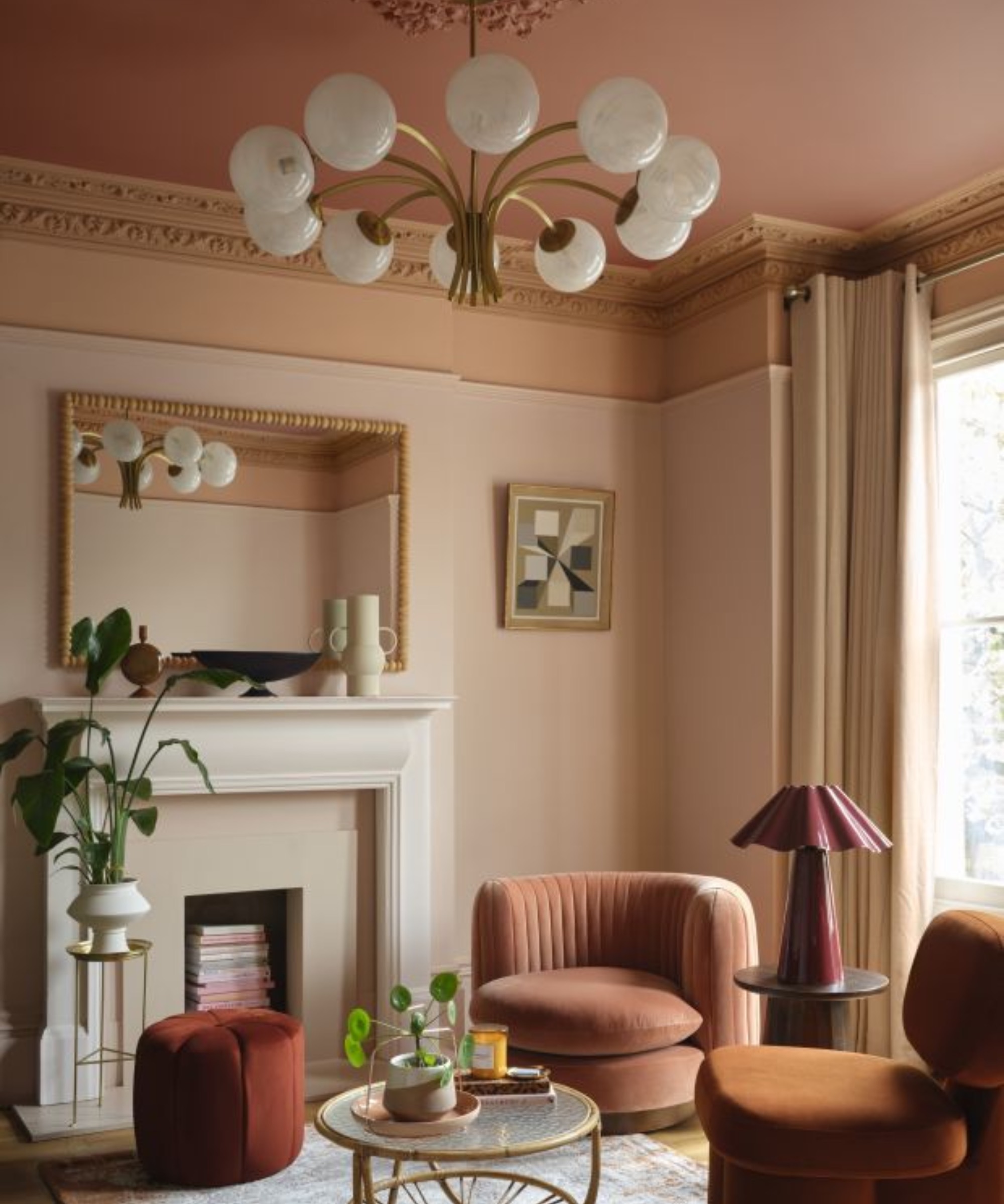 Peach living room painted in Benjamin Moore&#039;s Louisiana Hot Sauce CC-124, Firenze AF-225, Mrytle Beach 061, Queen Anne Pink HC-60 with rust swivel chair and fireplace