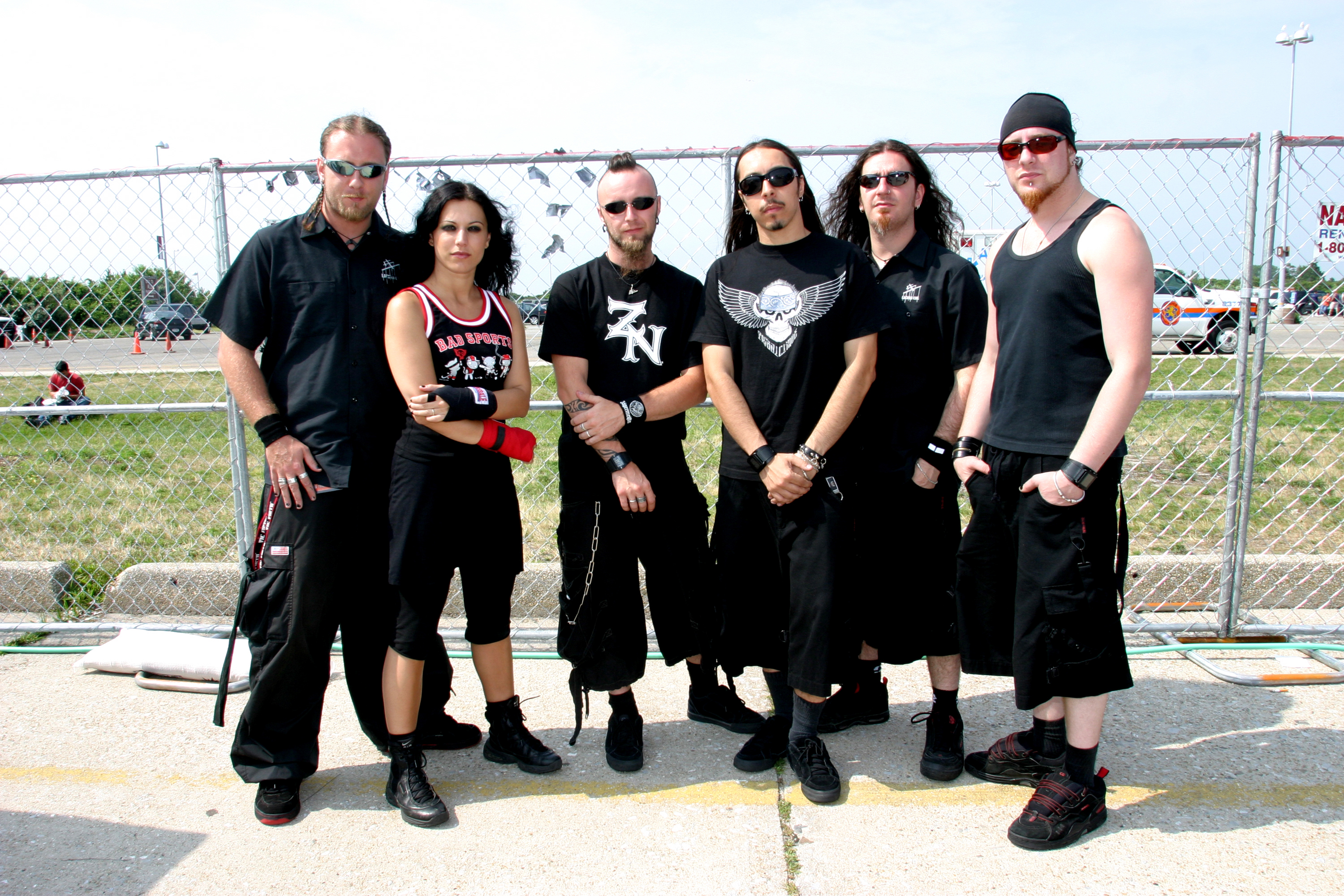 Lacuna Coil in front of a fence in 2004