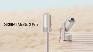 Xgimi MoGo 3 Pro in a field with a projector deployed on a wooden table