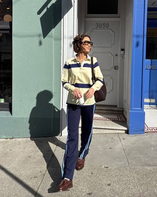 woman wearing polo shirt, adidas pants, and loafers spring outfit