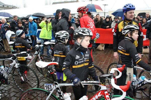 Young fans hold the pro bikes during the sign in