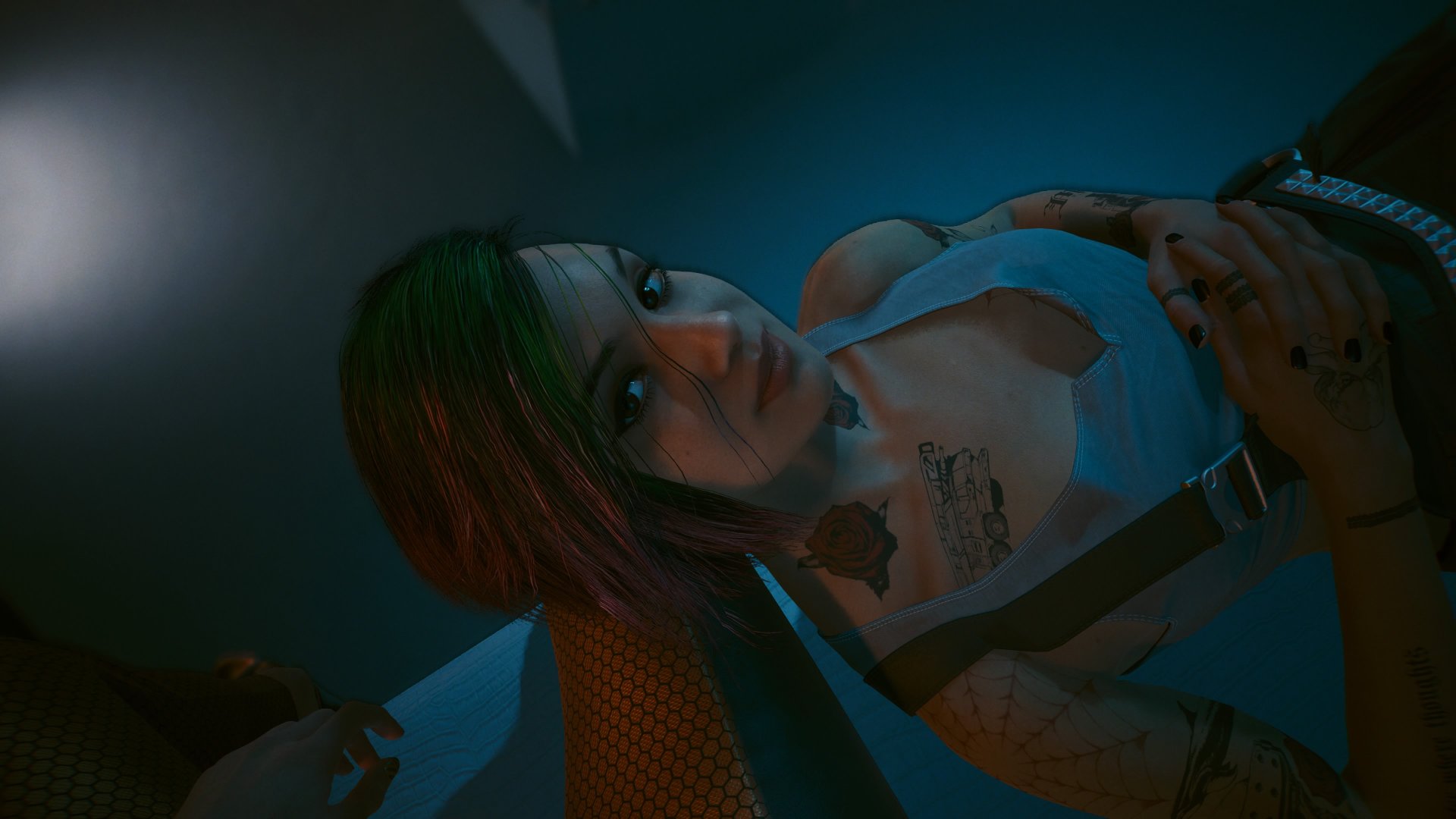 In Cyperpunk 2077, Judy rests on V's lap during a romantic hangout