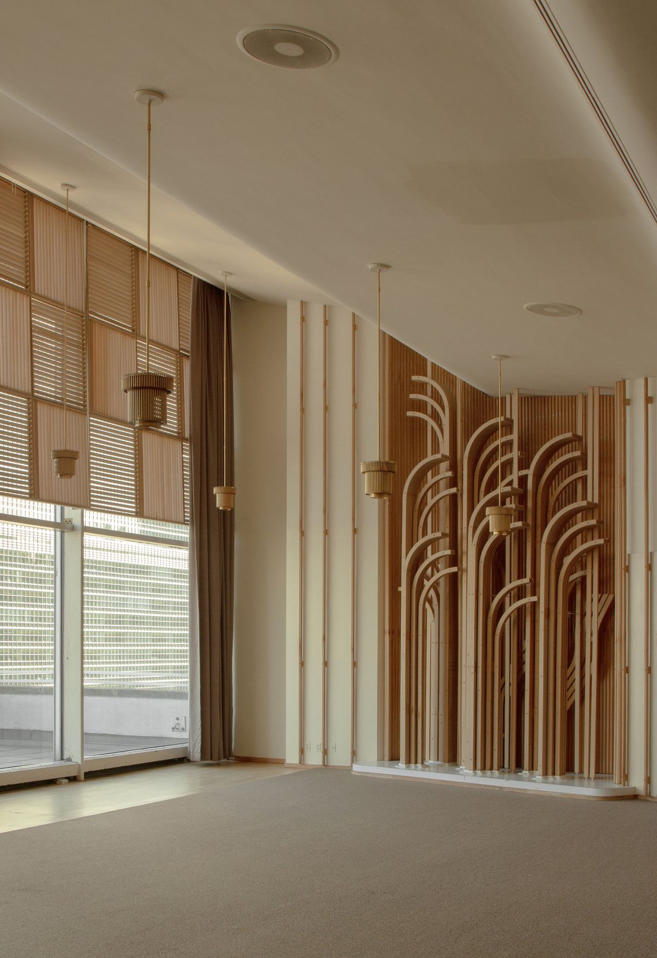A conference space features a highly inventive, wooden-carved design immersing viewers in an intimate and mysterious atmosphere.