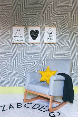 Children's room with black and white geometric wallpaper and rocking chair