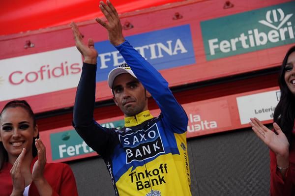 Alberto Contador gives himself a hand on the podium.