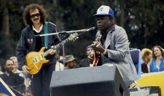 Carlos Santana (left) and John Lee Hooker perform onstage at Golden Gate Park in San Francisco, California on June 23, 1985
