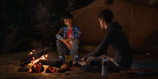 Sean and Daniel sitting around a campfire in Life is Strange 2