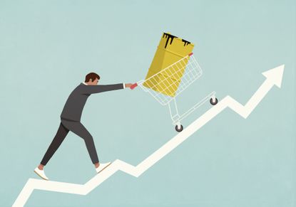 Businessman pushing oil barrel in shopping cart up line graph arrow 