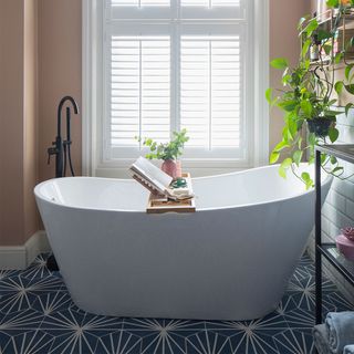 peach and blue bathroom with freestanding bath