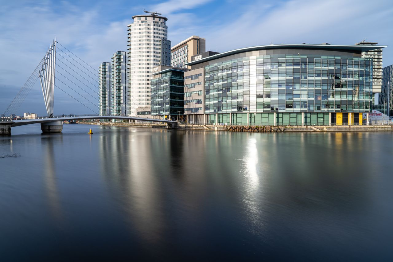 A cityscape reflected in water on a sunny day taken with the Sony A7R V