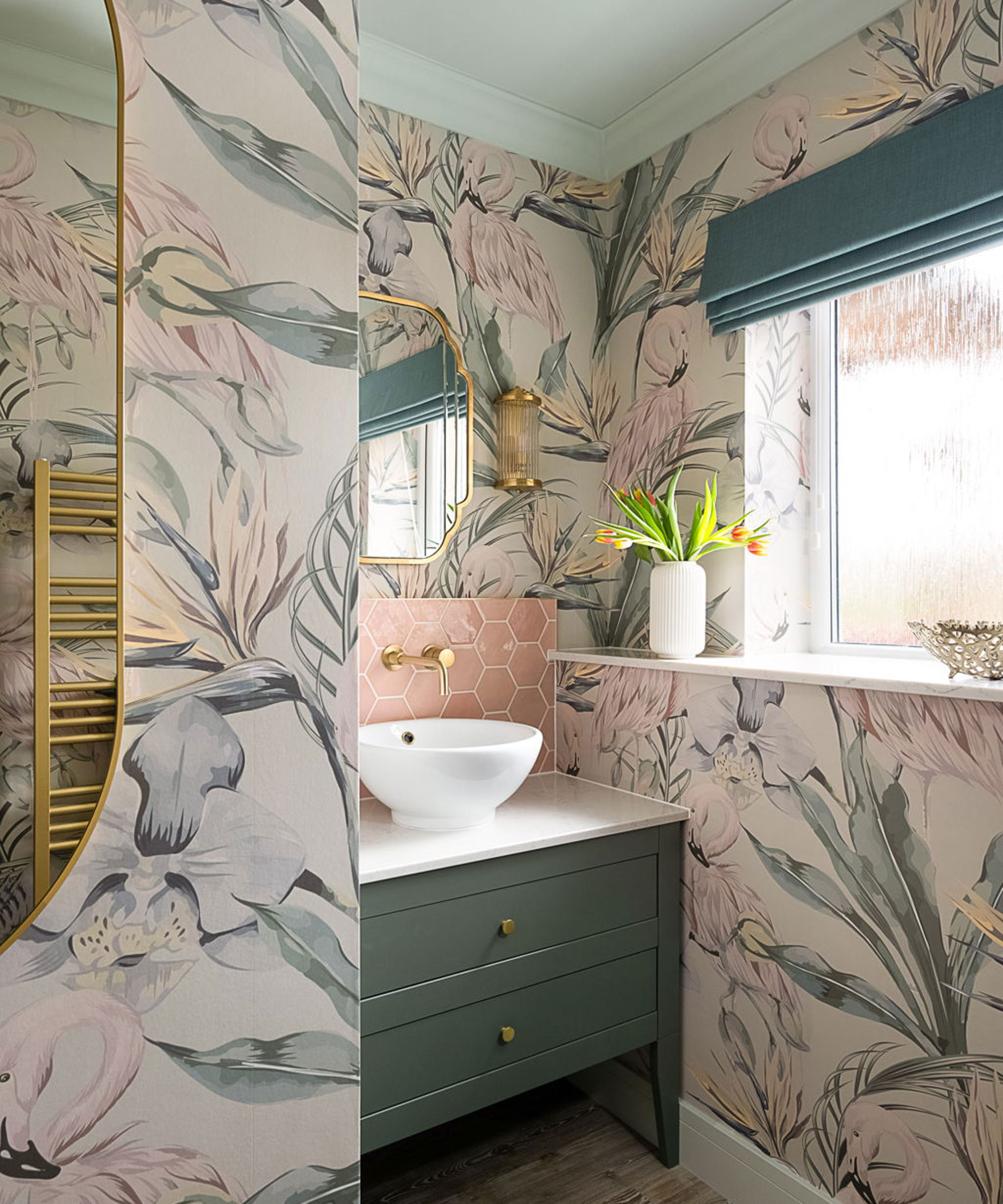 small pink and green bathroom with wallpaper and green bathroom vanity unit