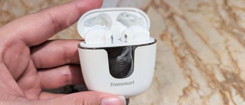 Tronsmart Onyx Ace Pro wireless earbuds inside case with lid open, held in one hand
