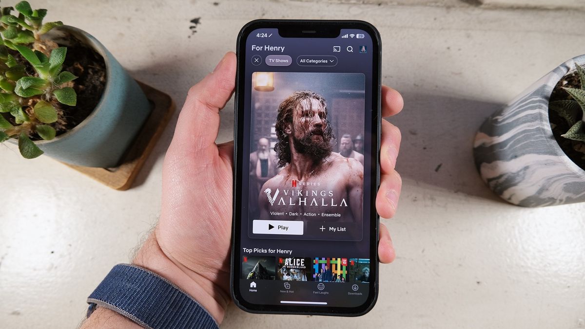 The new-look Netflix app shows a poster for Vikings: Valhalla on an iPhone