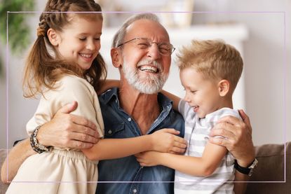 Grandfather hugging grandchildren