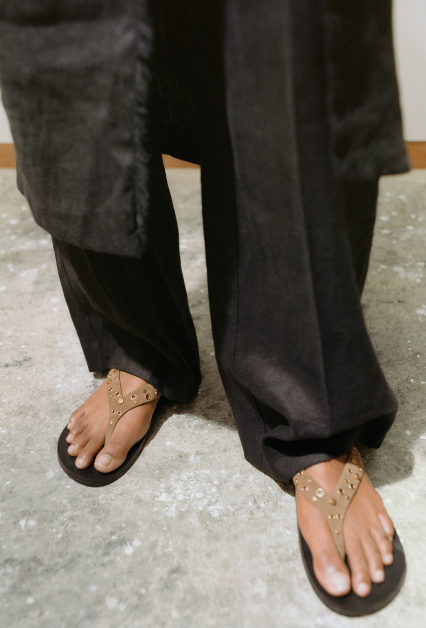 An image of studded flip-flops from Mango.